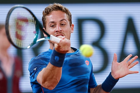 Roberto Carballes Baena plays a shot against Djokovic